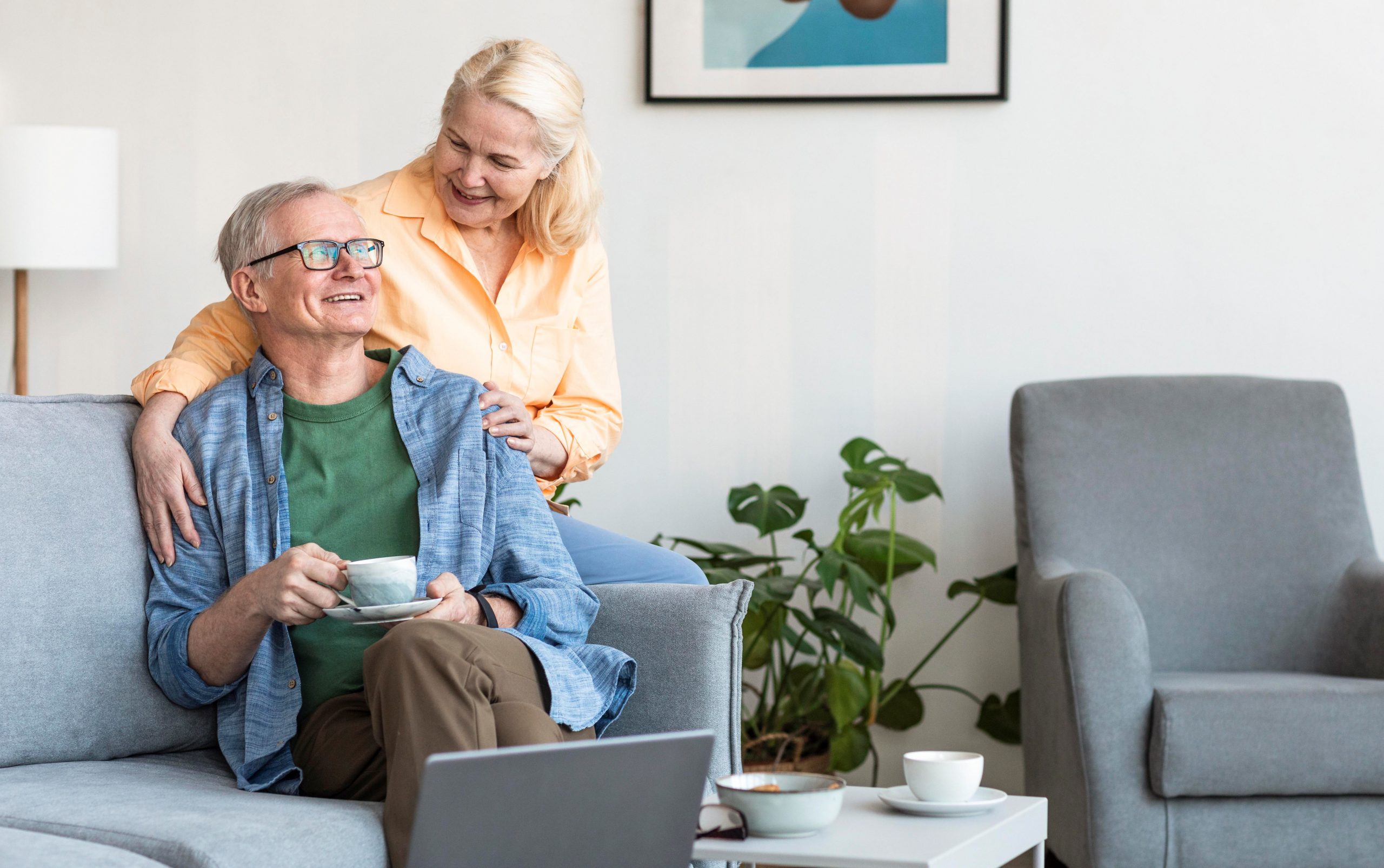 medicare-advantage-FP Happy senior couple in living room illustrates blog "What Is Medicare Advantage Annual Enrollment Period?"