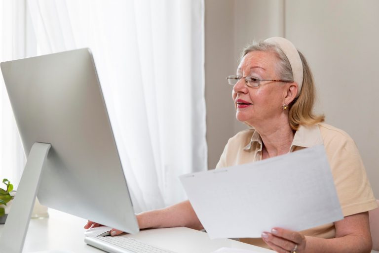 Senior female looking at computer illustrates blog "How Many Types of Medicare Advantage Plans Are There?"