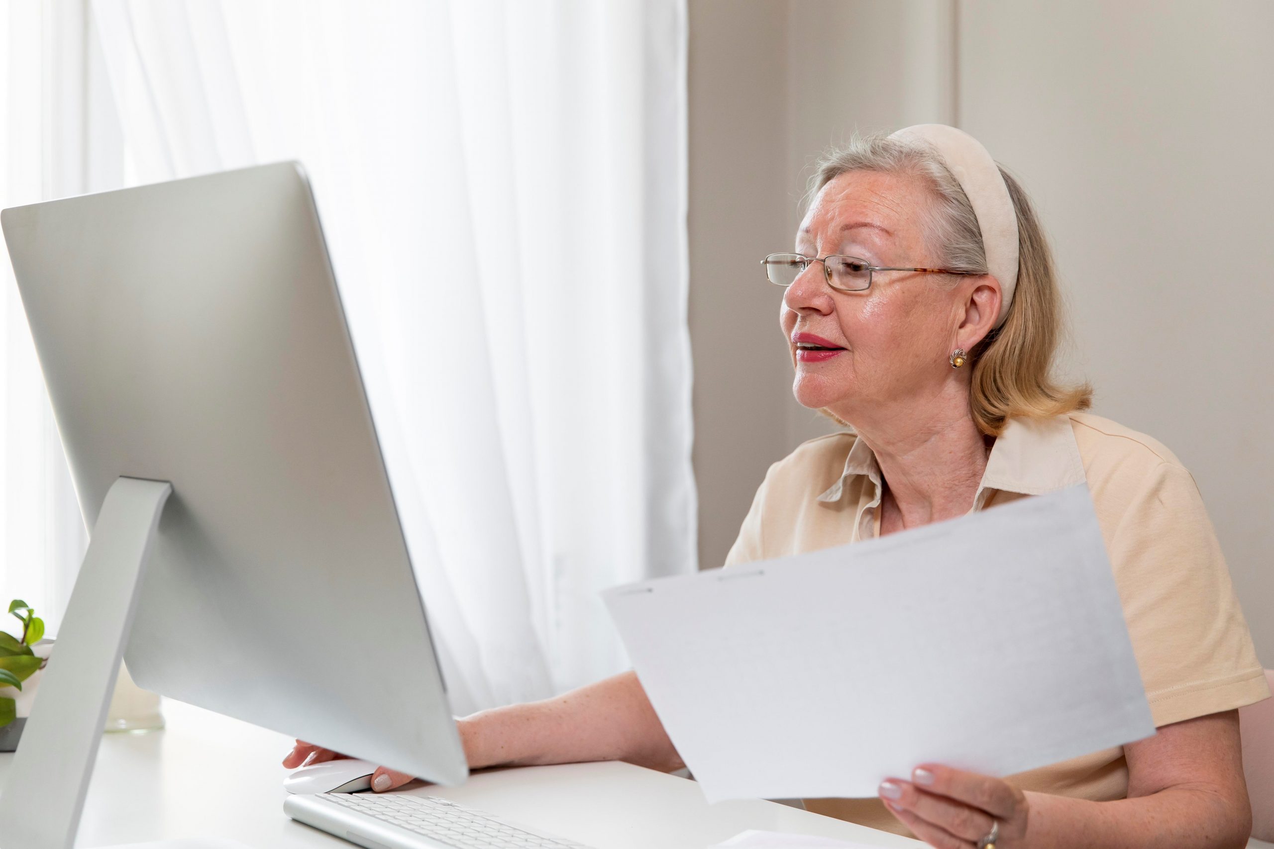Senior female looking at computer illustrates blog "How Many Types of Medicare Advantage Plans Are There?"