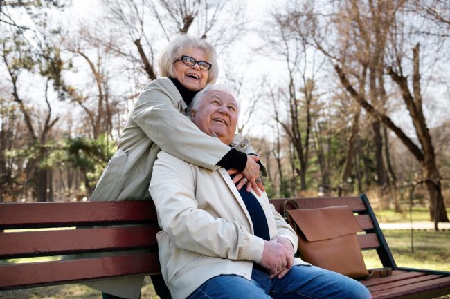 Senior couple in garden illustrates blog "When to Enroll in a Medicare Advantage Plan?"