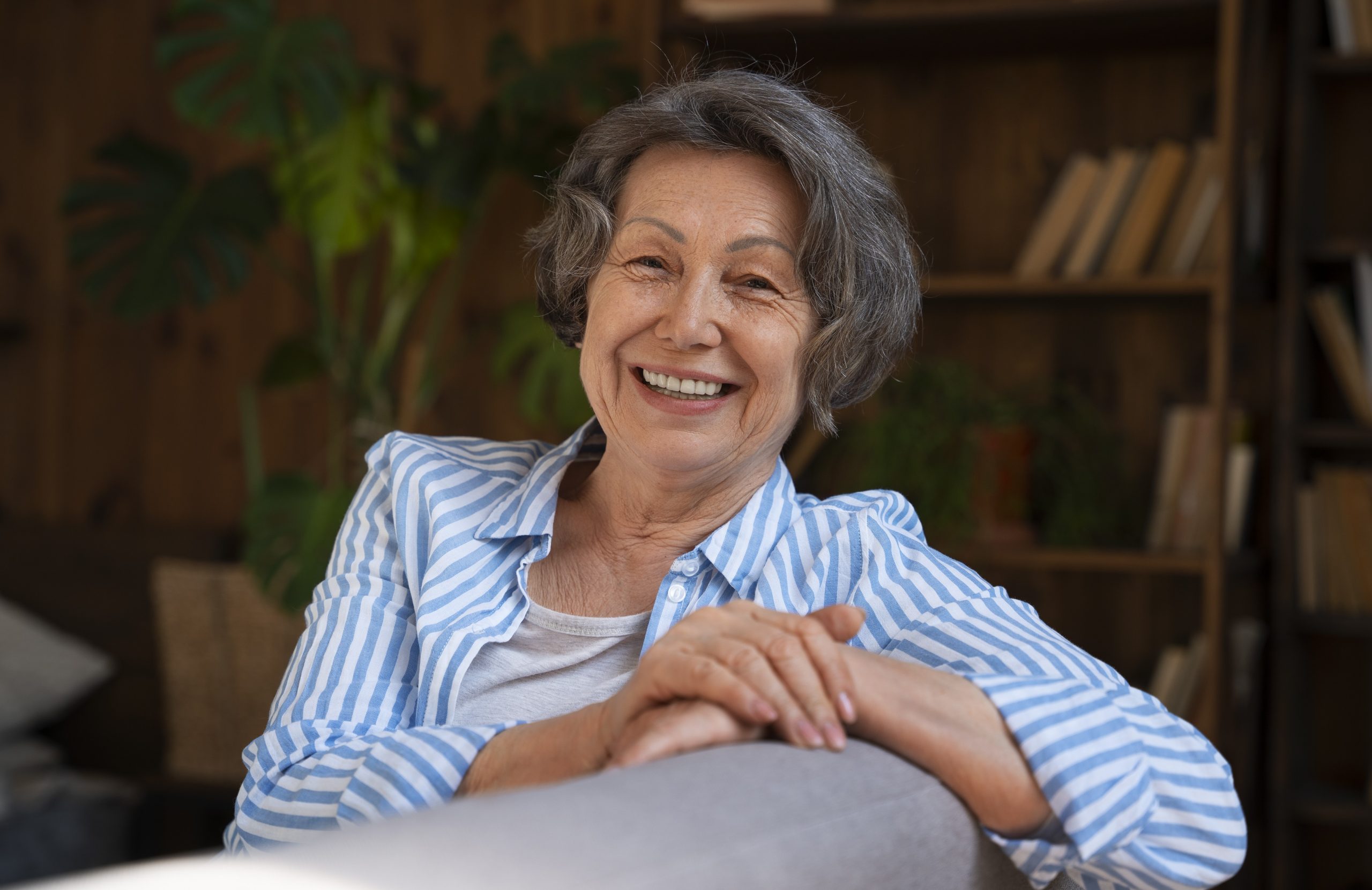 Lady leaning against the back of sofa illustrates blog "What Is Medicare Part C?"