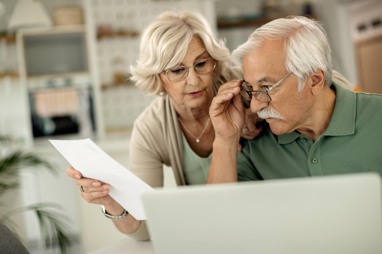 8386 Senior couple reviewing Medicare vision hearing coverage options at home