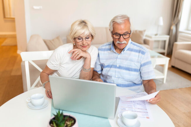 senior couple doing Medicare plan review to save money