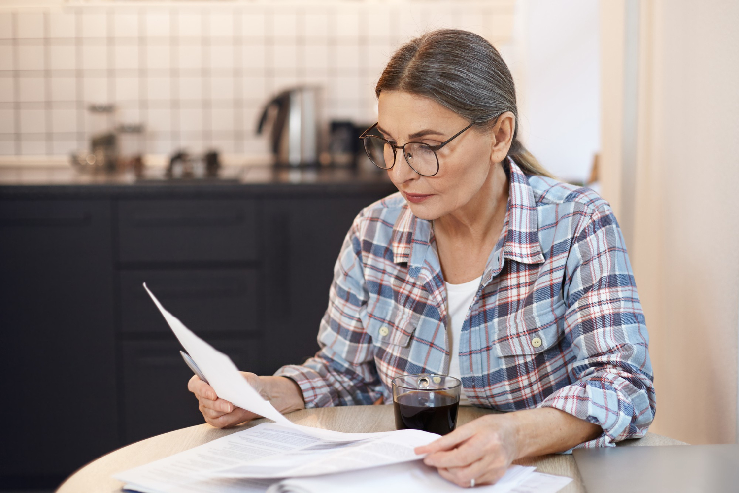 Older adult reading a Medicare Summary Notice and reviewing healthcare expenses Older adult reading a Medicare Summary Notice and reviewing healthcare expenses